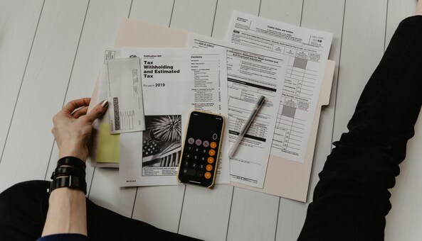 A lady looking over at her tax documents