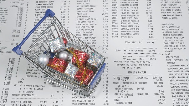 A trolley filled with gifts and receipts signaling tax