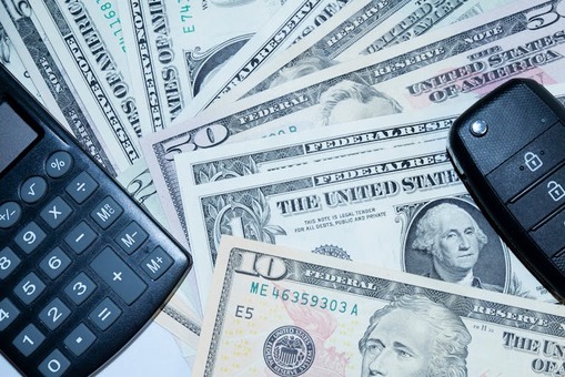Dollars and a calculator on the table