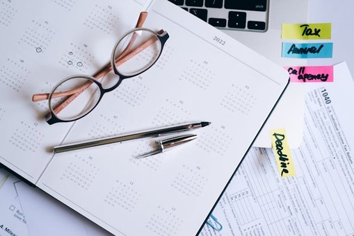 A split image of a calendar and tax documents